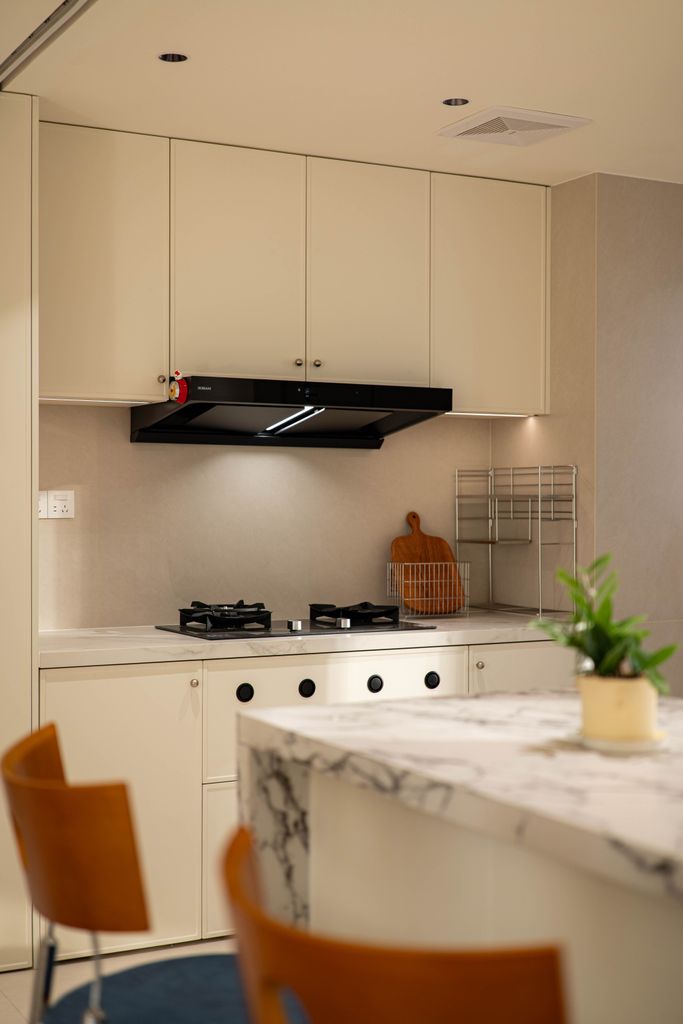 Stylish indoor kitchen with marble countertop and sleek modern decor.